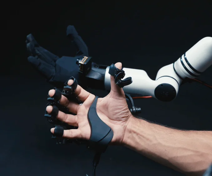 A hand wearing Aero UMI beside Aero Hand mounted on a robot arm.